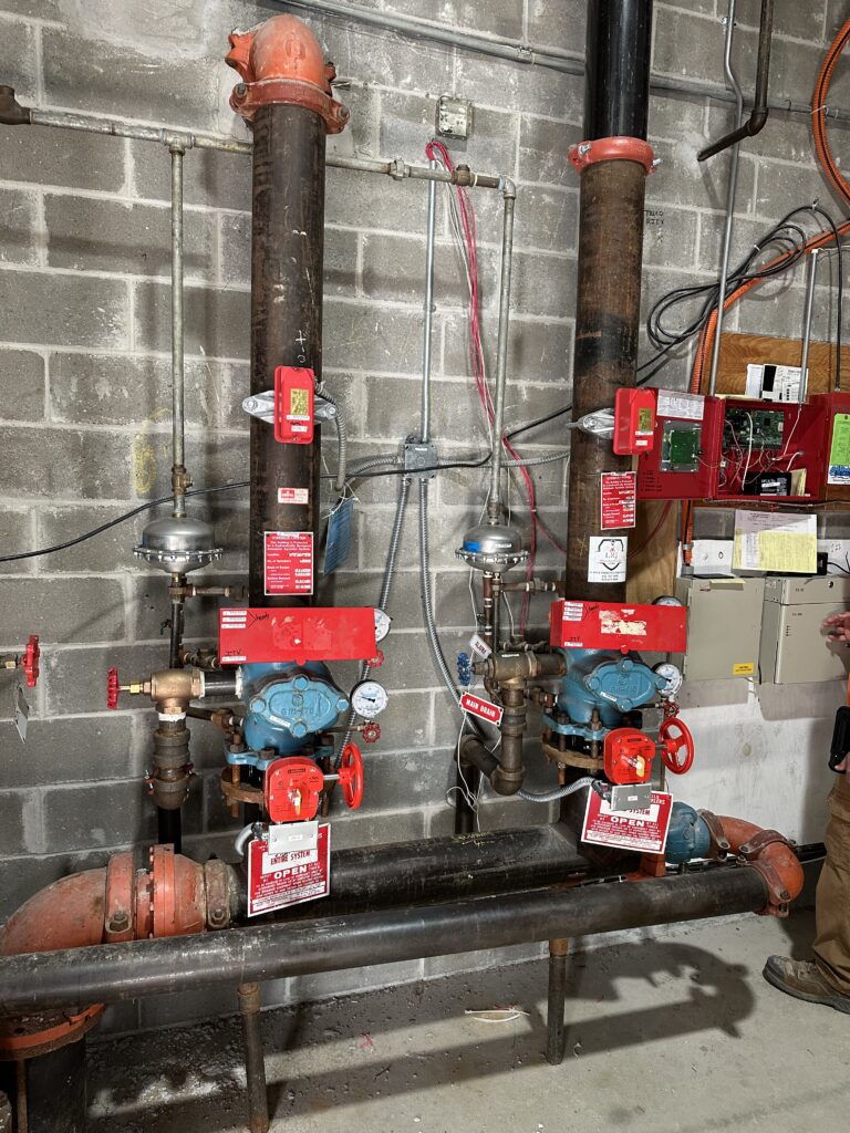 fire system pipes against brick wall